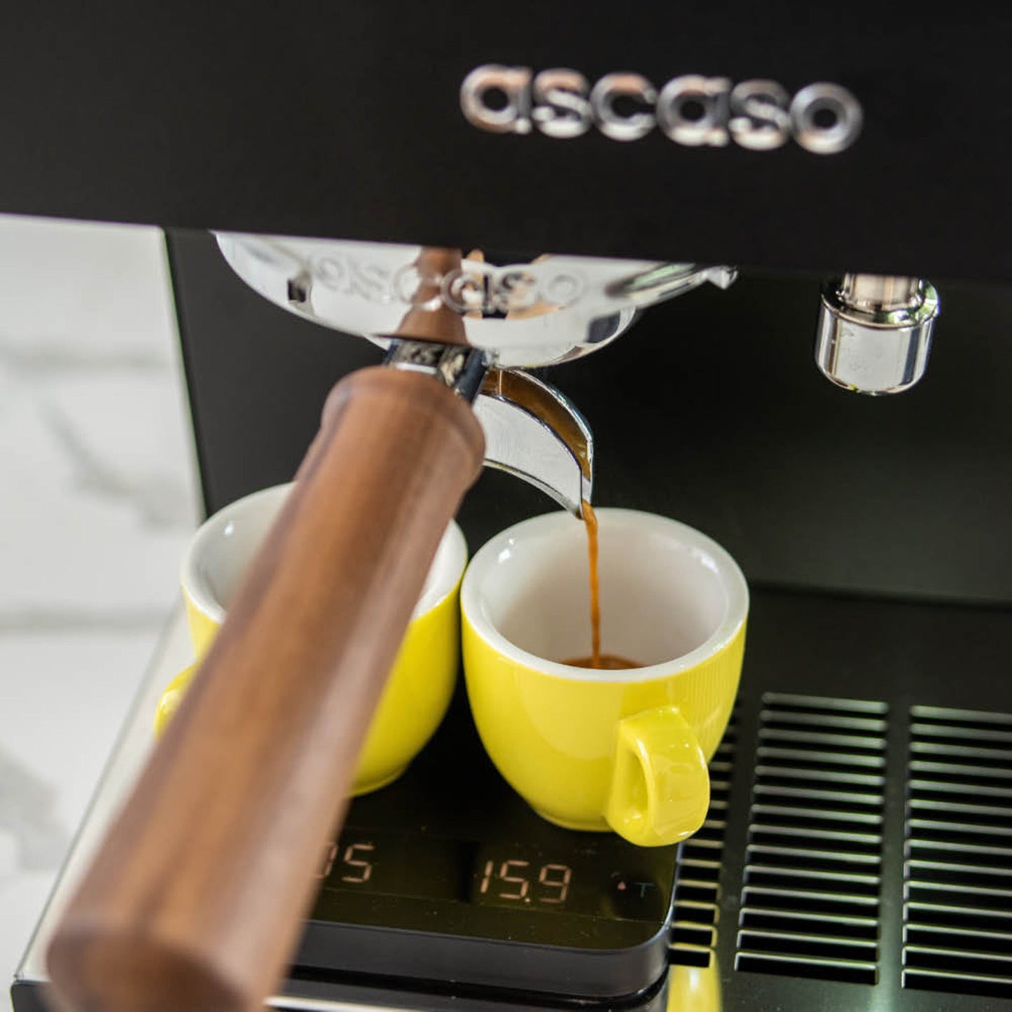 Ascaso Steel Duo Plus V2.5 PID Dual Thermoblock Espresso Machine in black, pulling a double espresso into two cups