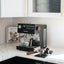 Ascaso Steel Duo V2.5 PID Dual Thermoblock Espresso Machine in black, on a marble kitchen counter with cups and a tamper