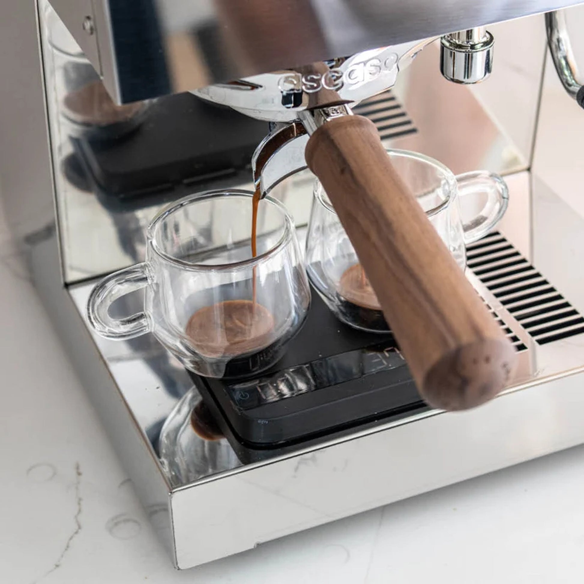 Ascaso Steel Duo V2.5 PID Dual Thermoblock Espresso Machine in inox stainless steel, espresso extracting into two glass cups on a scale