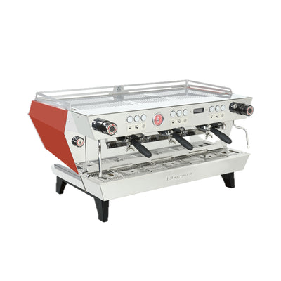 La Marzocco KB90 three group commercial espresso machine in red, angled view showing the straight-in group heads
