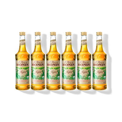 Six 750ml glass bottles of Monin Organic Agave Nectar in a row