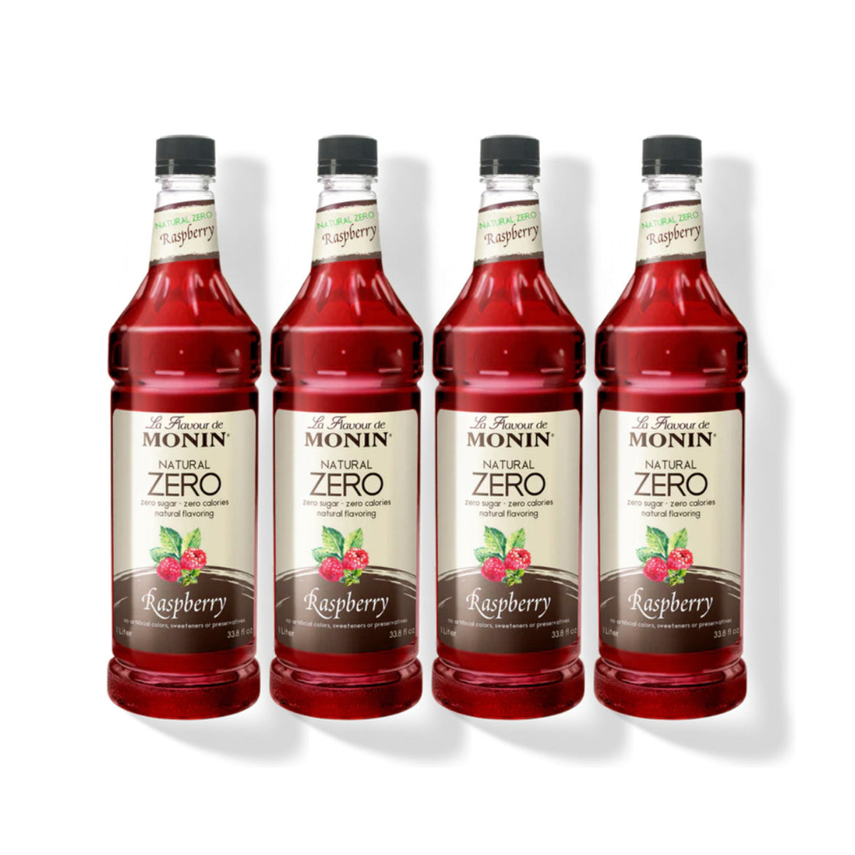 Four 1L plastic bottles of Monin Natural Zero Raspberry syrup in a row