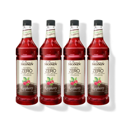 Four 1L plastic bottles of Monin Natural Zero Raspberry syrup in a row