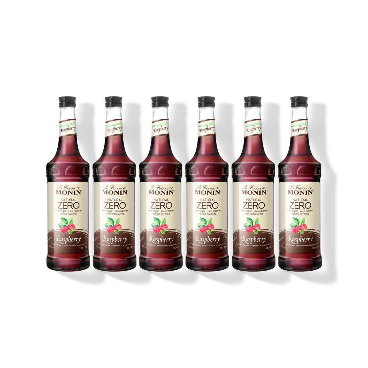 Six 750ml glass bottles of Monin Natural Zero Raspberry syrup in a row
