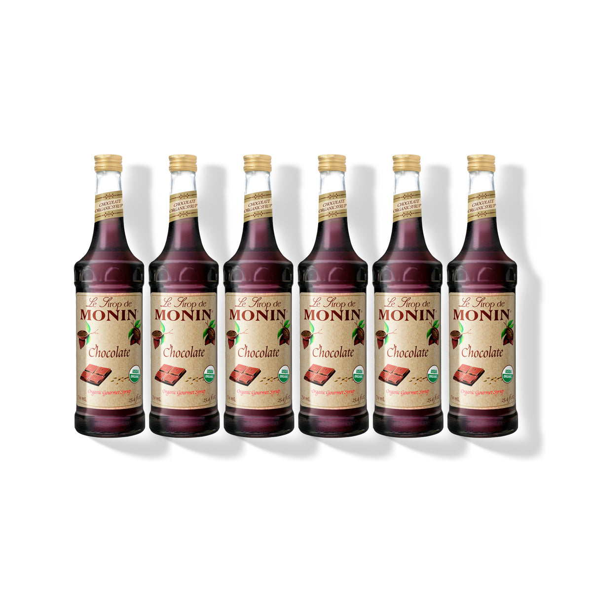 Six 750ml glass bottles of Monin Organic Chocolate syrup in a row