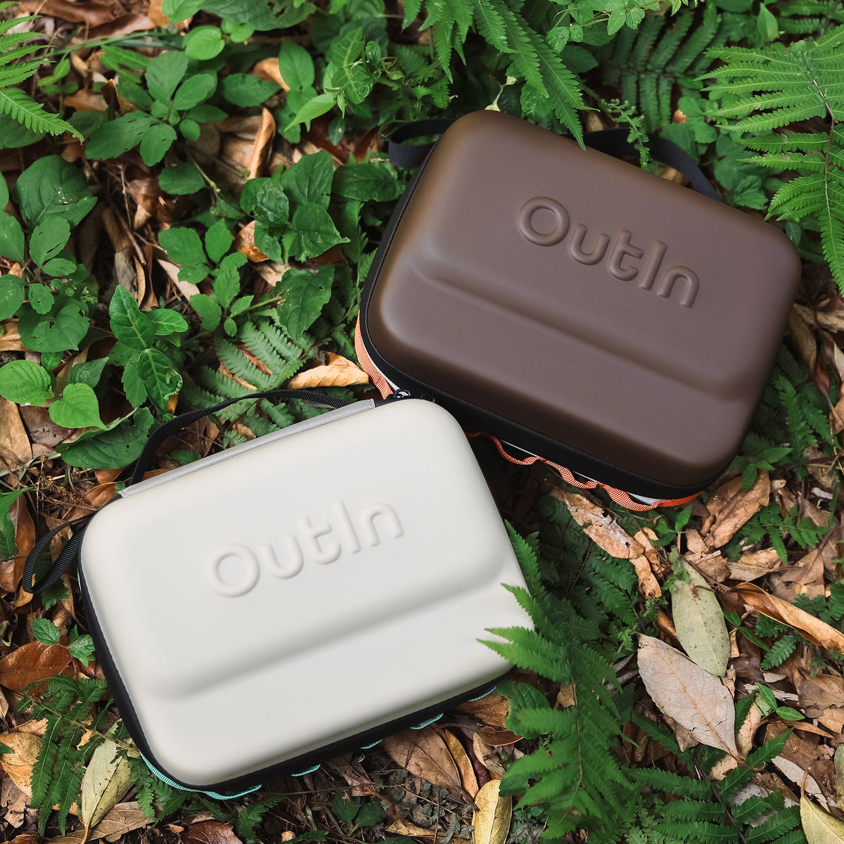 OutIn EVA Protective Case Plus in maple brown, resting on a forest floor