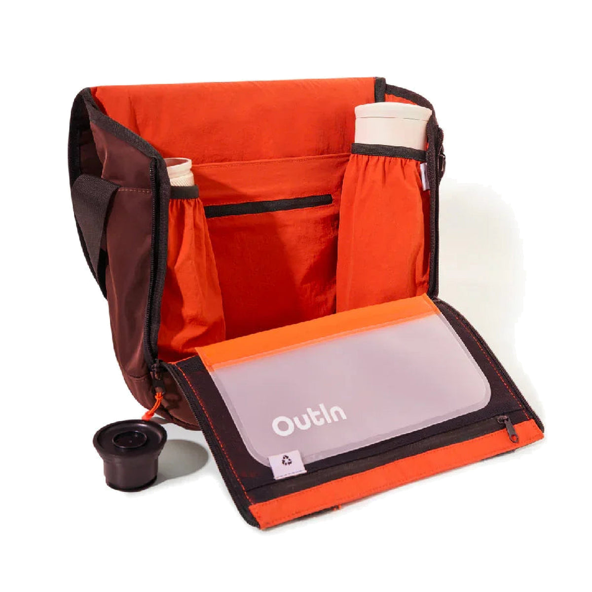 OutIn Flex Messenger Bag in amber brown, open, showing the padded interior