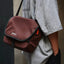 OutIn Flex Messenger Bag in amber brown, worn over the shoulder