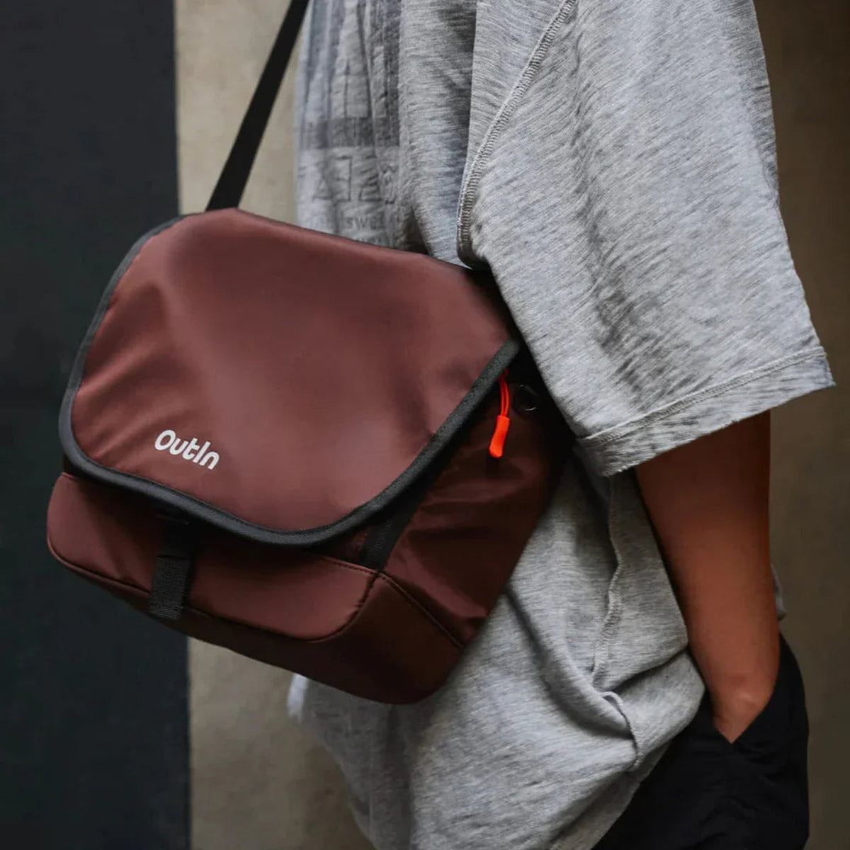 OutIn Flex Messenger Bag in amber brown, worn over the shoulder