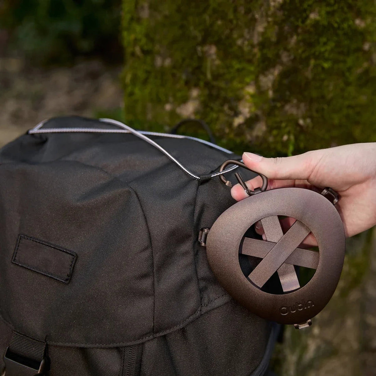 OutIn Foldable Coffee Stand, clipped to the outside of a pack