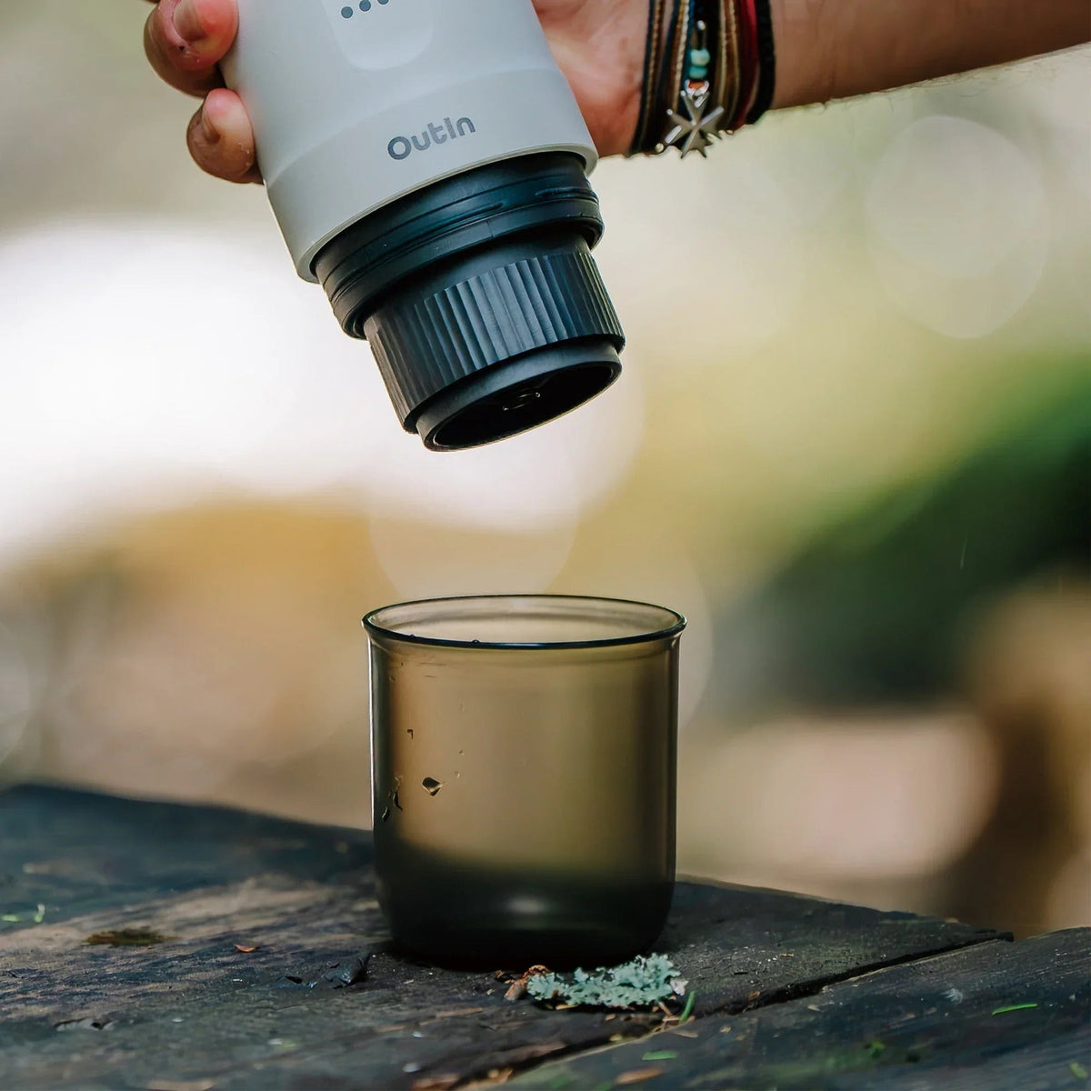 OutIn Nano Portable Espresso Machine Cup, being filled outdoors