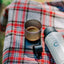 OutIn Nano Portable Espresso Machine Cup, on a picnic blanket