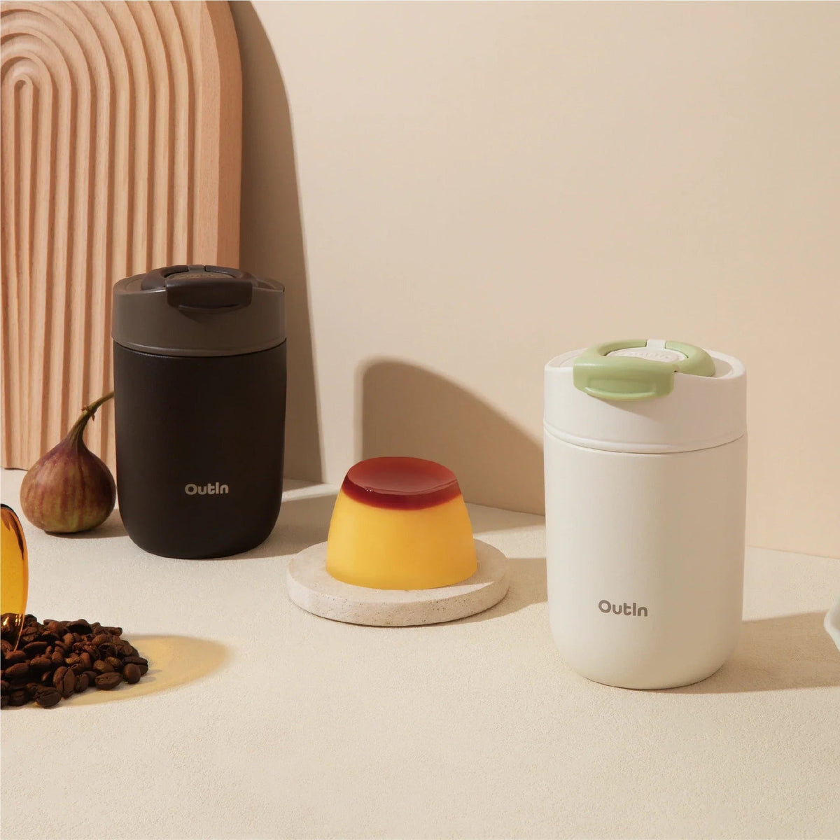 OutIn Travel Tumbler in sand white, styled on a kitchen counter
