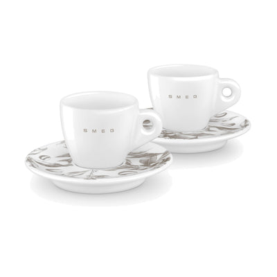 SMEG espresso cup and saucer set in white, two white cups on saucers with a coffee-plant print
